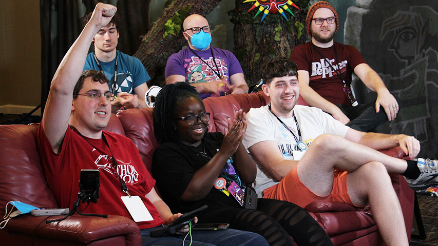 Attendees celebrating a moment on the couch